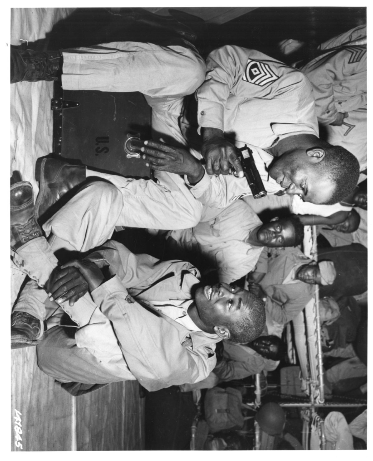 An image of First Sergeant James Sims shows Private John Stephens his .45. Both are soldiers of the 76th CA.