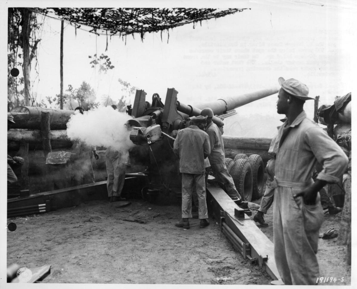 Historical image showing Loading a 155mm M1 rifle of Btry B, 49th Coast Artillery, Section 2, Black troops operating. of Black American soldiers during WWII