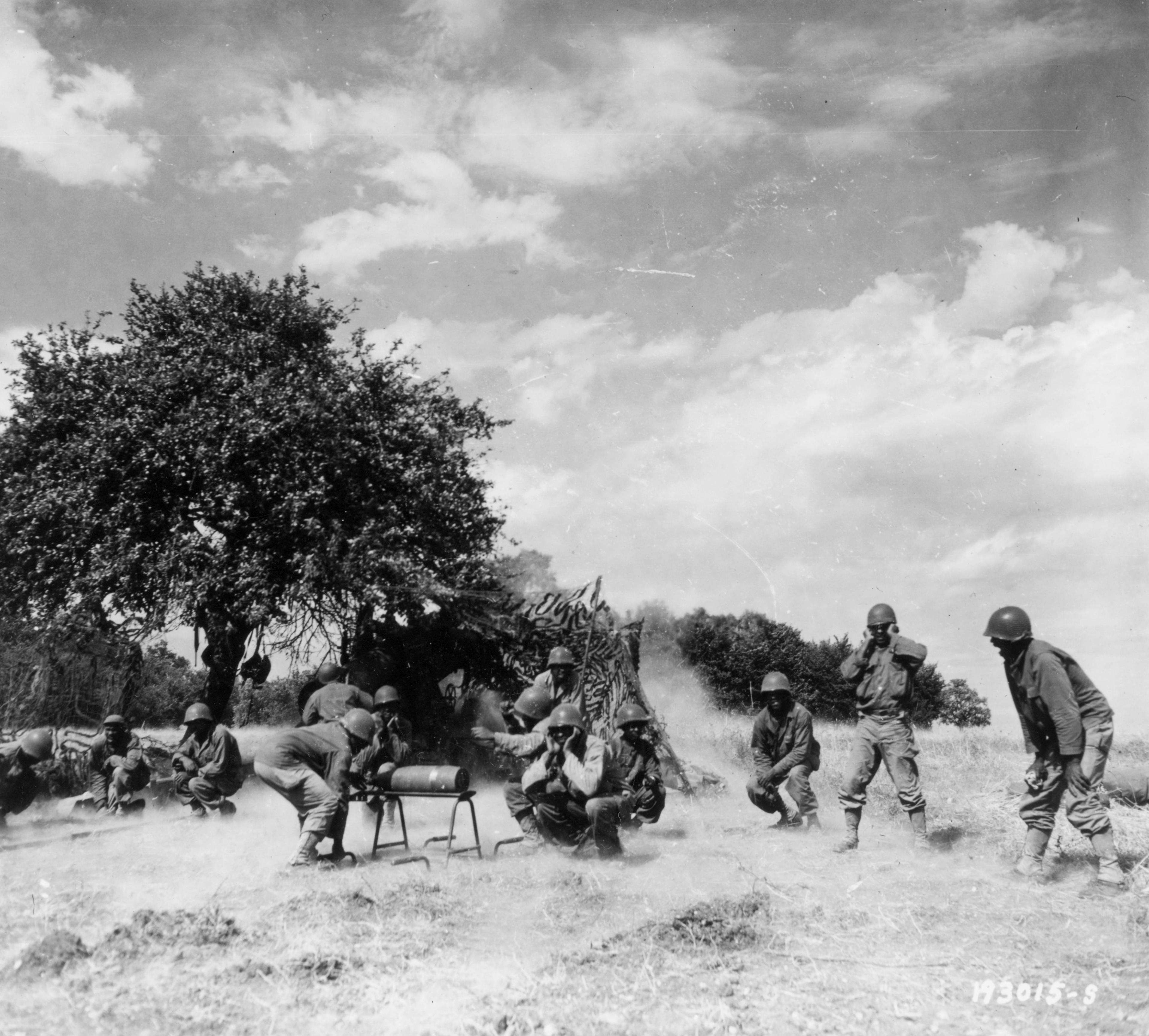 Historical image showing Another projectile from an 8-inch howitzer is fired to stop the German retreat across the Seine River. of Black American soldiers during WWII